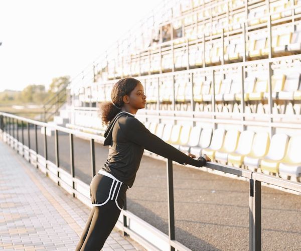 Person stretching in a sunlit park, feeling energized and free.